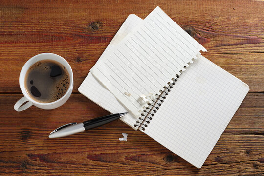 Notebook with coffee and pen