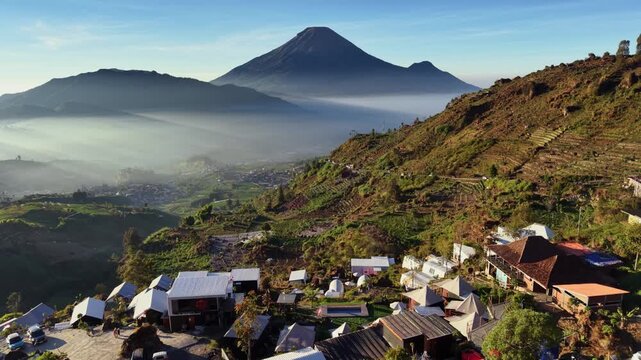 Aerial view of Sikapuk Hill and Villa Dieng featuring terraced hills and mountain scenery in Indonesia.