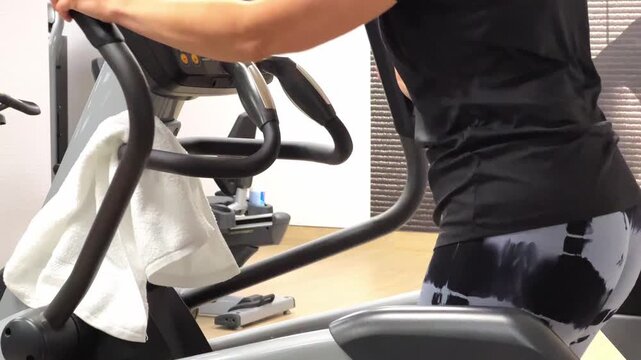 A person is exercising on an elliptical machine in a gym, showing different angles of the workout routine during both uphill and flat movements.