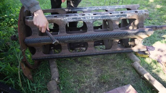 old red combine harvester repair threshing machine replacement of whips on the drum welding work to improve the efficiency of the unit