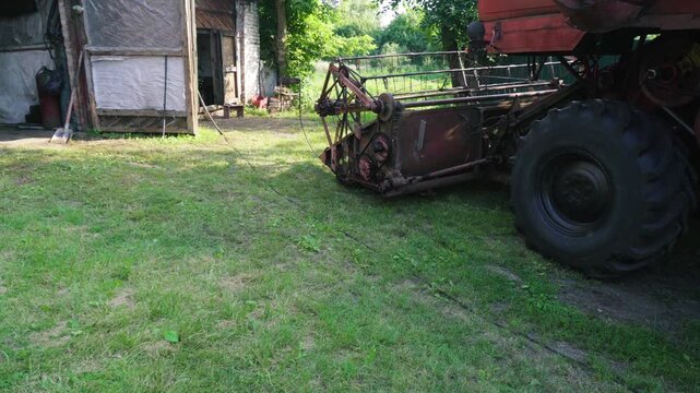 old red combine harvester repair threshing machine replacement of whips on the drum welding work to improve the efficiency of the unit