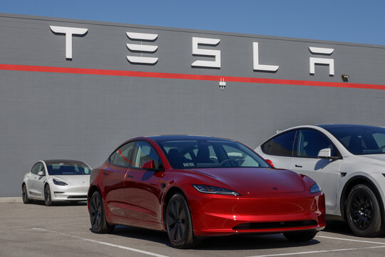 Tesla Model 3 Electric Sport Sedan at a dealership. Tesla offers the Model 3 with up to 321 miles driving range. MY:2026