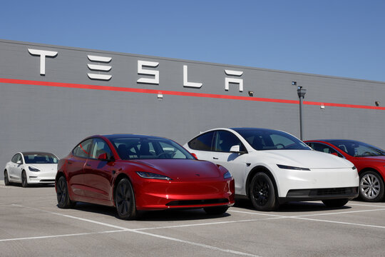 Tesla Model 3 and Model Y at a dealership. Tesla offers the Model 3 and Model Y with up to 327 miles driving range. MY:2026