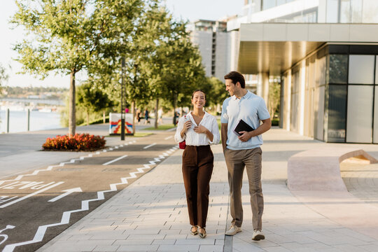 Korean woman and Caucasian man enjoying a sunny stroll by the riverside
