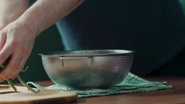 Clean green beans inside a stainless steel bowl on a kitchen counter