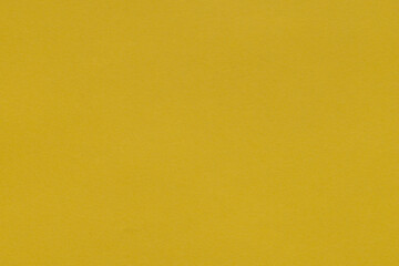 Naklejka premium Yellow textured paper background or mustard yellow abstract texture,Macro,Close-up of a vibrant mustard yellow textured paper background, featuring a fine grain surface and uniform color pattern,