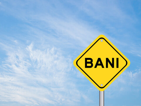 Yellow transportation sign with word BANI (Brittle, Anxious, Non-linear and Incomprehensible) on blue color sky background
