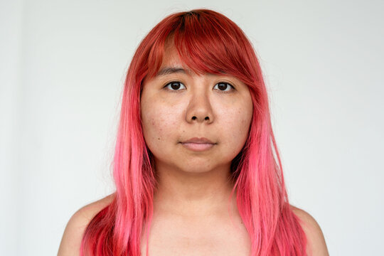Portrait with vibrant pink hair.