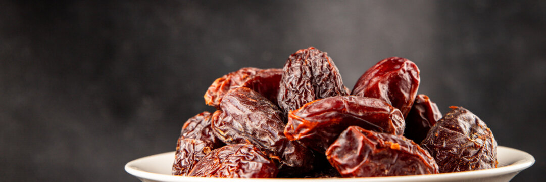 Dates sweet dessert edible fruits of the date palm food preparation tasty snack fresh and delicious gourmet food background on the table rustic food top view copy space keto and paleo 