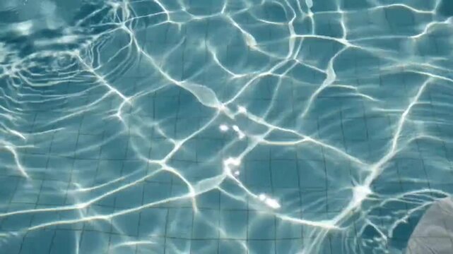 Water rippling in a swimming pool with reflection relaxation recreation movement surface leisure ripple liquid serene sports light clear hobby video wave blue with calm