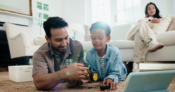 Child, dad and high five with toy car for robotics, tablet or online tutorial for remote control in home. Family, son and father with tech for guide with engineering, junior mechanic or development
