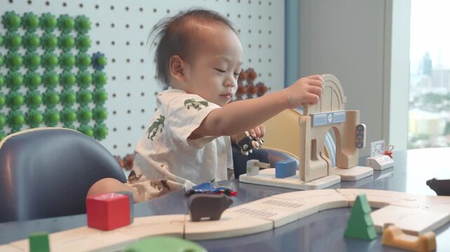 A young child engages creatively with colorful wooden blocks and toys, fostering fine motor skills and imaginative play in a bright, stimulating environment.