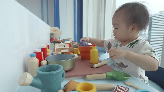 A child engages with a vibrant play kitchen setup, filled with colorful utensils and food items. This scene captures the joy of imaginative play, encouraging creativity and cognitive development throu