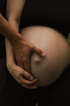 pregnant woman holding her belly