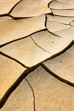View of the cracked clay surface of the Tuzbair salt flats with intricate patterns and dry soil textures in Mangystau District, Mangystau Region, Kazakhstan.