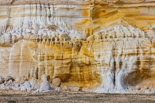 View of the eroded limestone cliffs at Tuzbair with distinctive white and yellow geological formations in the desert landscape of Mangystau District, Mangystau Region, Kazakhstan.