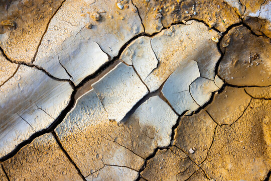 View of cracked earth and dry soil textures in the arid desert landscape of Tuzbair, Mangystau District, Mangystau Region, Kazakhstan.