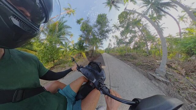 Two Helmeted Adults Ride a Scooter Along a Tropical Concrete Road, Spherical 360 View Highlights Adventure Travel and Outdoor Lifestyle Vertical video.