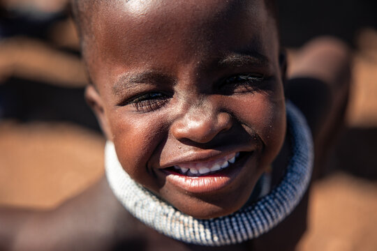 Himba child smiling looking at camera in Namibia