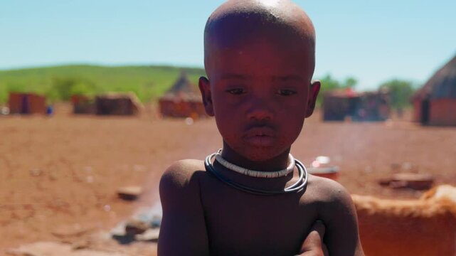 Portrait of a Himba child in a traditional Namibian village