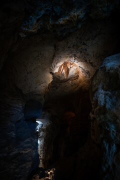 View of Grutas do Poco Velho featuring limestone rock formations and natural cave textures with dramatic lighting in Cascais, Lisboa, Portugal.