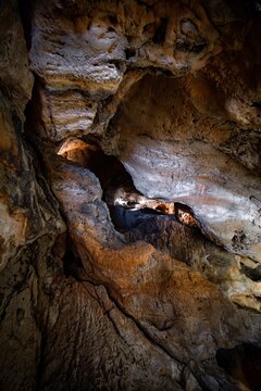 View of Grutas do Poco Velho featuring textured limestone rock formations and natural cave interiors in Cascais, Lisboa, Portugal.