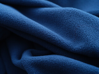 Soft blue fleece fabric with detailed folds and texture. Shallow depth of field. Close up. © Stepan Popov