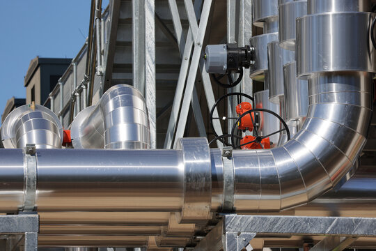 View of insulated data centre cooling pipework with valve actuators