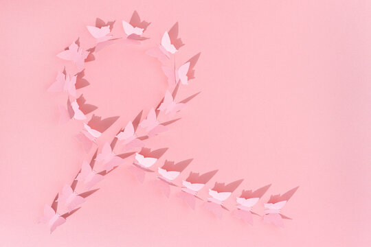 pink paper butterflies ribbon breast cancer awareness minimalist abstract background. copy space