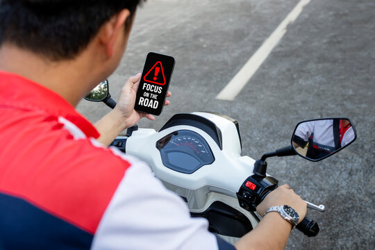 Distracted Scooter Rider Using Smartphone With Focus on the Road Warning