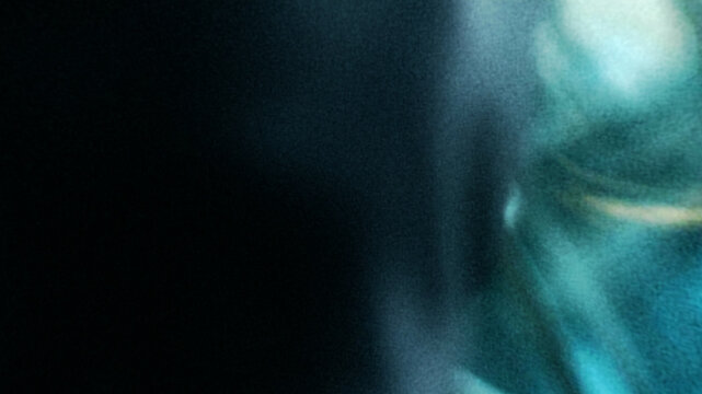 Dark cinematic blue light leak texture with subtle grain and abstract glow effect for overlay design
