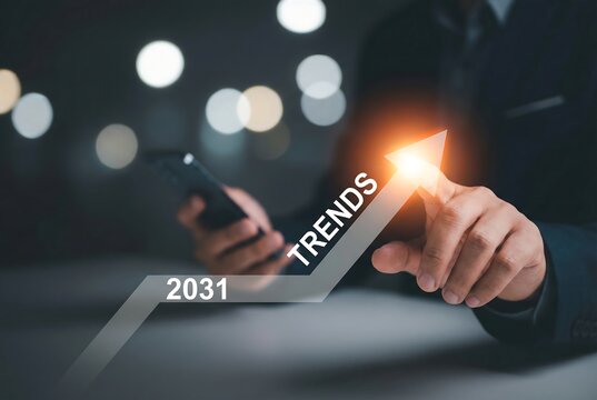 Person pointing at a glowing upward arrow trend graph for the year 2031 on a digital interface
