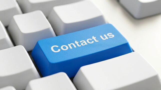 A bright blue contact us key on a modern white computer keyboard.