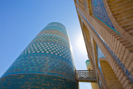 UZBEKISTAN - KHIVA - KALTA MINOR MINARET ALSO KNOWN AS THE GREEN MINARET BUILT IN 1852 - HISTORIC ISLAMIC ARCHITECTURE WITH TURQUOISE TILES ATTRACTS TRAVEL AND CULTURE TOURISM