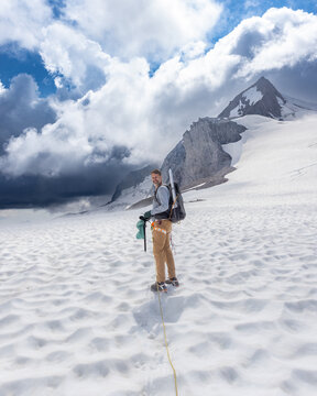 Roped man trekking across a glacier in Garibaldi Park, British Columbia