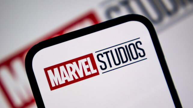 Marvel Studios cinematic brand logo on smartphone display with blurred background.