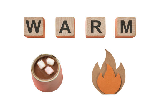 Warm and cozy flat lay with wooden alphabet blocks spelling the word warm next to hot chocolate marshmallows and a decorative paper fire flame