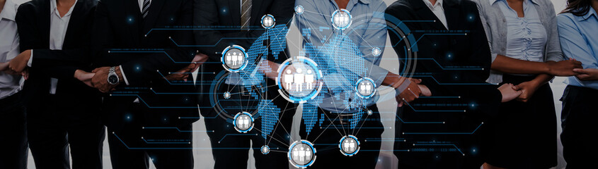 A diverse business team stands together, showcasing collaboration enhanced by digital networks, representing innovation, strategy, and modern workplace dynamics in a creative setting. Trope © InfiniteFlow