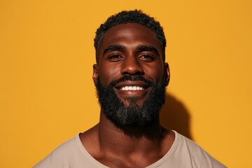 Obraz premium Studio portrait of a friendly Black man with a yellow backdrop