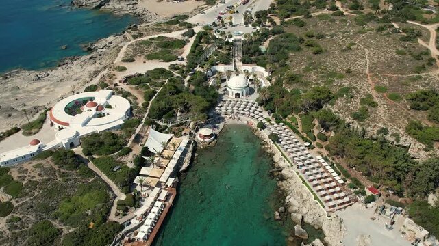 Stunning aerial drone footage of Kallithea Springs in Rhodes, Greece, showcasing the historic thermal springs, beautiful Mediterranean coastline, turquoise sea and surrounding architecture. 