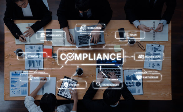 A diverse group of professionals engage in a meeting focused on compliance strategies, highlighting governance, regulation, and transparency within a modern office environment. Trope