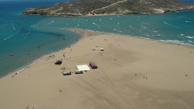 14 June 2026 Prasonisiou, Rodos: Dynamic aerial drone footage of windsurfers riding the waves at Prasonisi Beach in Rhodes, Greece. Bird's-eye view of windsurfing action, turquoise Mediterranean water