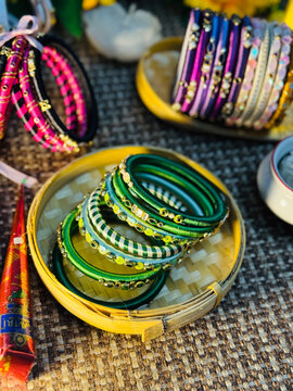 Stack of colorful indian bangles on a rustic table
