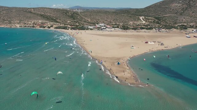 14 June 2026 Prasonisiou, Rodos: Dynamic aerial drone footage of windsurfers riding the waves at Prasonisi Beach in Rhodes, Greece. Bird's-eye view of windsurfing action, turquoise Mediterranean water