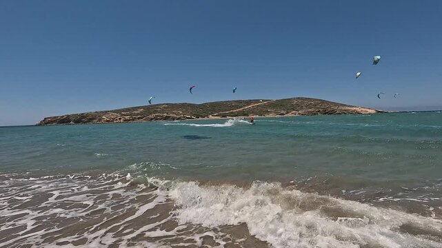 14 June 2026 Prasonisiou, Rodos: Dynamic aerial drone footage of windsurfers riding the waves at Prasonisi Beach in Rhodes, Greece. Bird's-eye view of windsurfing action, turquoise Mediterranean water