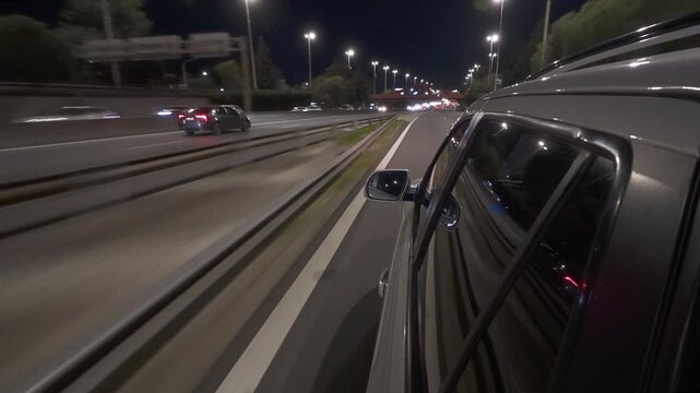 SUV / car driving through highway / freeway at night side mirror POV