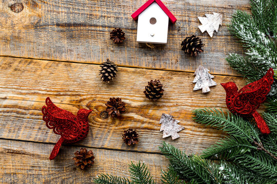 Christmas eve with spruce branches, toys and pine cones on wooden background top veiw mock-up