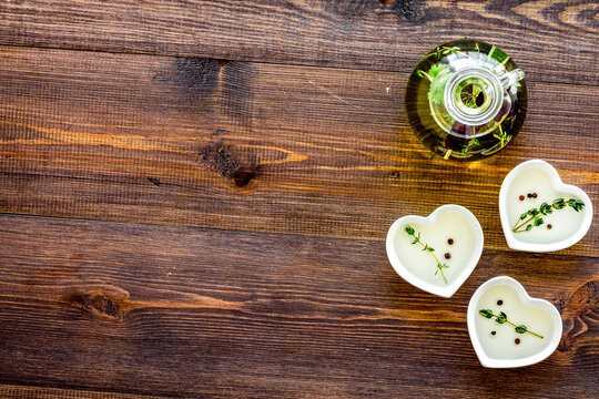 home cooking with fresh greenery and organic oil on wooden table background top view mock up