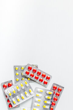 doctor's work desk in hospital with pills white background top view mockup