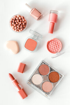 Makeup background with rounge, powder and tools on white table top view